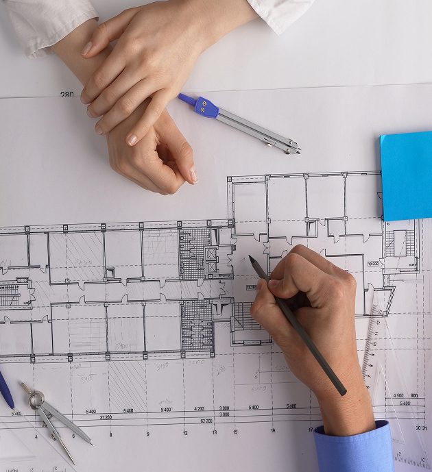 Designers reviewing floor plan draft