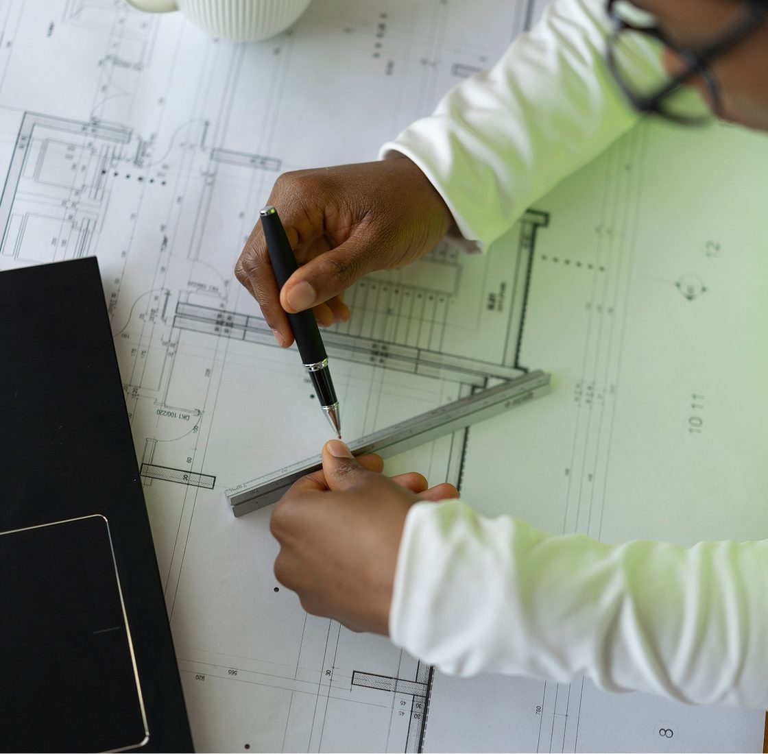 Architect using ruler on design